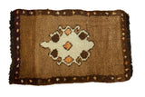 Vintage hand-knotted Turkish Oushak rug, ornate ivory medallion on plush brown field.