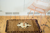 Plush hand-knotted Oushak rug with ornate ivory, orange, and brown medallion.