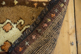 Vintage Oushak rug's plush pile, fringe, and tightly woven hand-knotted foundation with small colorful motifs.