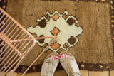Plush pile of vintage Oushak rug featuring ivory, bronze, and tangerine diamond motifs.