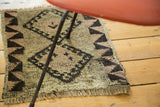 Hand-knotted Oushak rug with secured fringe and reciprocating geometric border.