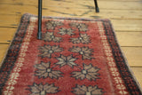 Hand-knotted Turkish Oushak rug mat, cherry red field, geometric motifs, visible wear.