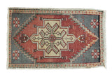 Vintage Oushak rug mat with faded cinnabar red, grey, and ivory stepped hexagonal medallion.