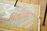 Secured ivory fringe and sunflower yellow border on the vintage Oushak rug.