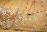 Close-up of vintage Oushak runner, showing stepped floral motif in bronze, tangerine, and grey.