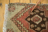 Hand-knotted Oushak rug corner pile with soft seafoam, dark copper, and chocolate patterns.