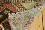 Vintage Oushak rug corner, off-white fringes, geometric pile in copper, brown, green, hand-knotted back.