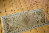 Vintage Oushak rug: hexagonal medallion with wave motif, star designs, soft tones, and etching.