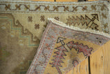 Hand-knotted weave and fringed edge of a vintage Oushak rug, showing its foundation.