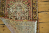 Distressed cinnabar pile and hand-knotted foundation of the vintage Oushak runner.