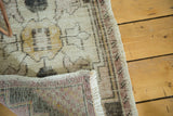 Distressed pile texture, secure edge, and hand-knotted reverse of a vintage Oushak rug.