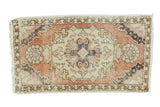 Distressed vintage Oushak runner with octagonal medallion in faded peach, ivory, and charcoal.