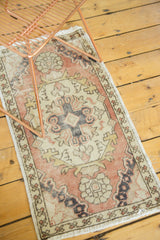 Faded peach border and central quatrefoil medallion on a vintage Oushak runner.