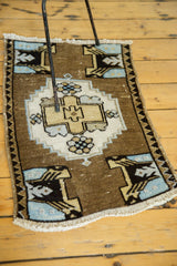Vintage Oushak rug detail: stepped medallion, floral, and planter motifs in bronze, blue, sand.