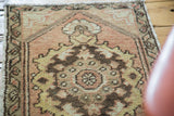 Hand-knotted vintage Oushak rug with faded peach hexagonal medallion and floral motifs.