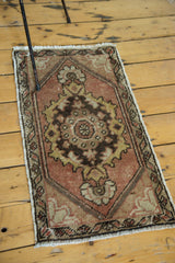 Oushak rug corner, faded peach, ivory, gold floral spandrel, barber pole border.