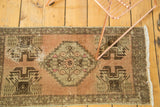 Faded peach and greige geometric planter motifs, revealing time-softened texture on Oushak runner.