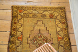 Stepped lozenge medallion with floral diamond motifs in gold, mauve, and brick red.