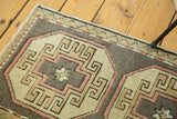 Oushak runner detail: blush, ivory, and grey crab style medallion with etched outlines.