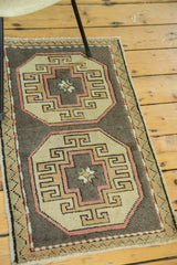 Detail of vintage Oushak runner's geometric blush, ivory, and natural grey medallion.