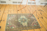 Intricate quatrefoil medallion, floral spandrels, pistachio, aqua, mauve on Oushak rug.