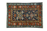 Vintage Karaja square rug, dark indigo, brilliant madder red, geometric double diamond medallions.