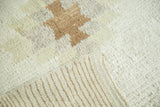 Textured vintage Tulu rug pile showing stepped coffee brown motif and striped foundation.