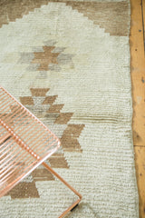 Vintage Turkish Tulu rug's textured ivory pile with stepped light coffee geometric patterns.