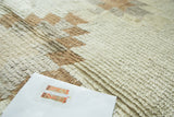Ivory and light coffee brown hand-knotted pile of the vintage Tulu rug with stepped details.