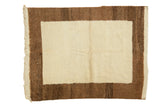 Simplistic vintage Tulu rug with plush ivory pile and thick milk chocolate brown border.