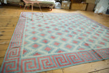 Vintage Dhurrie square rug, allover celadon and red diamond field with geometric wave border.