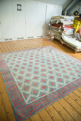 Geometric wave border detail on a vintage Indian Dhurrie, celadon green, red, ivory diamond field.