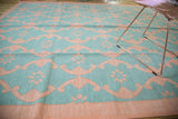 Hand woven Indian Dhurrie carpet featuring aqua turquoise and blush rose lattice design.