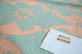 Hand woven Dhurrie rug with aqua turquoise blue and deep blush rose floral lattice.