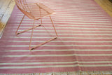 Hand woven vintage Dhurrie with variegated red and ivory horizontal stripes.