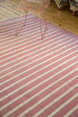 Ivory and red striated lines on a vintage hand woven Dhurrie carpet.