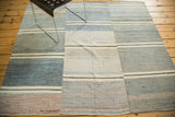 Modern hand-woven Turkish rag rug with asymmetrical denim blue, ivory, and charcoal stripes.