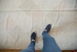 Hand woven Kilim texture featuring pale stone and blush diamond lattice design.
