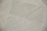 Hand woven Kilim carpet detail showing pale stone and blush lattice diamond design.