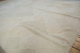 Subtle pale stone, slate grey, and blush diamond patterns on hand woven kilim.