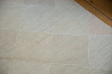 Hand woven Kilim texture with lattice diamond pattern in pale stone and slate grey.
