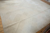 Hand woven Indian Kilim carpet featuring a lattice diamond design in pale stone, grey, blush.