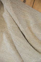 Thick, hand-woven texture on the natural tone underside of a new Kilim carpet.
