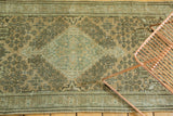 Evenly distressed vintage Sivas rug section with intricate patterns, antique peach and sea foam green.