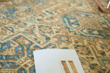 Time-softened geometric Karaja rug patterns in ivory, sky blue, and coffee brown.