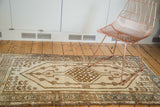 Distressed ivory and bronze oblong medallion on a vintage Turkish Kars runner.
