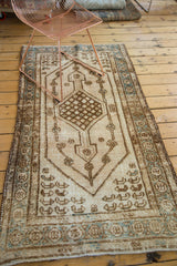 Distressed ivory Kars runner border with floral patterns in dark bronze and seafoam blue.