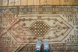 Distressed Turkish Kars runner showing oblong medallion, checkered pattern, arrows, and aqua accents.