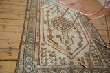 Vintage Kars runner detail revealing hard distressed texture, floral motifs, and aqua border.