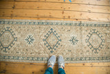 Vintage Karaja runner segment with geometric medallions, serpent border, ivory and moss green.